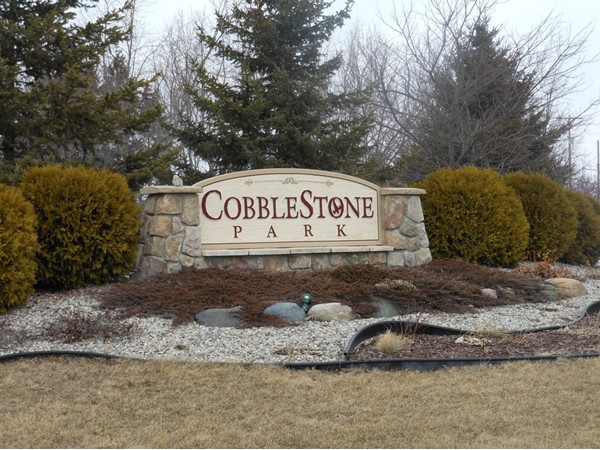 The welcoming entrance sign to Cobblestone Park