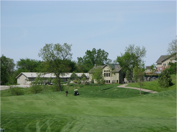 The 18th fairway, hole is to the left over the creek. Pool house, workout center and clubhouse