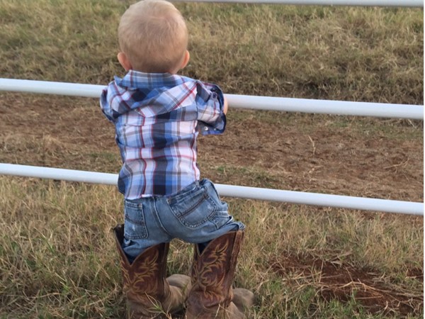 Starting them young on the ranch. Lil' farmer looking over the land in LeFlore County