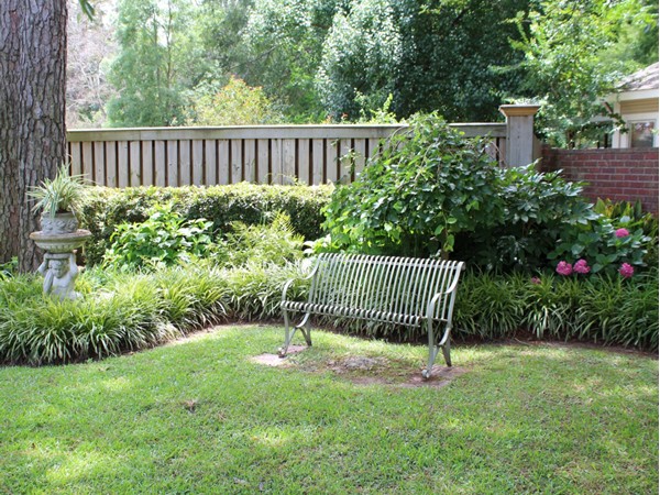 This quiet garden corner can be found in the luxurious neighborhood of Point Place