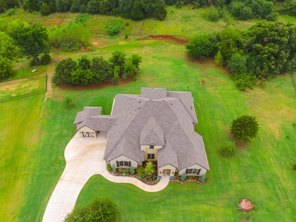 Aerial view of home with trees, large yard and room between neighbors