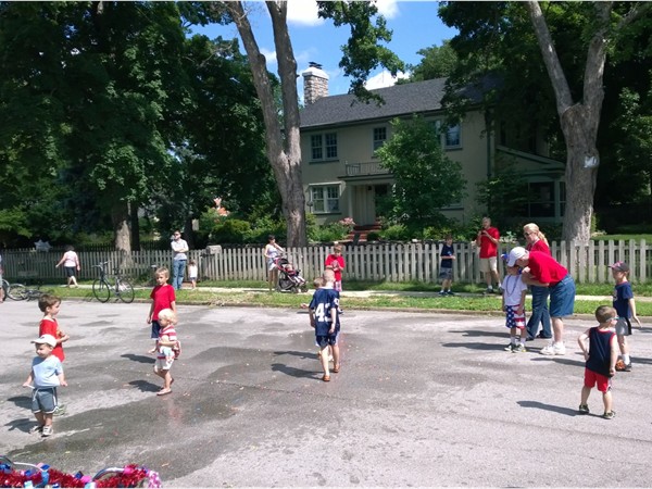 Neighbors in University Heights enjoy the Independence Day parade and kids water balloon fight 